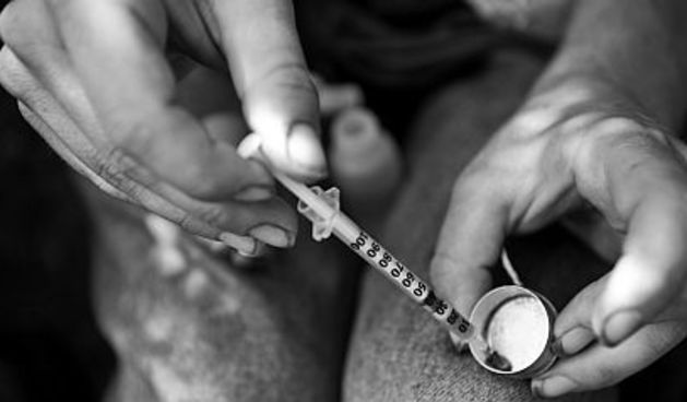 A longtime “maintainance” drug addict, “Joe” draws about 20 units of prepared heroin into an insulin syringe.