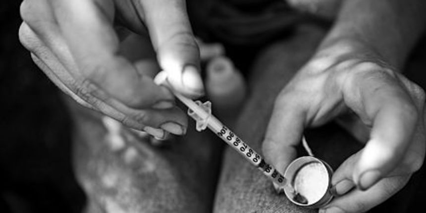 A longtime “maintainance” drug addict, “Joe” draws about 20 units of prepared heroin into an insulin syringe.