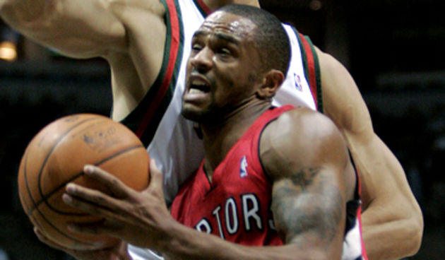 Toronto Raptors guard Juan Dixon (3) tries to drive past Milwaukee Bucks center Yi Jianlian of China during the first half of an NBA basketball game Tuesday, Nov. 6, 2007, in Milwaukee. (AP Photo/Morry Gash)