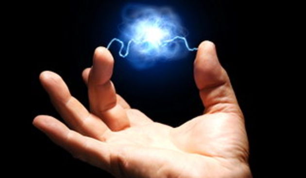 male hand with electricity arcing between thumb and middle finger with plasma ball suspended in the center