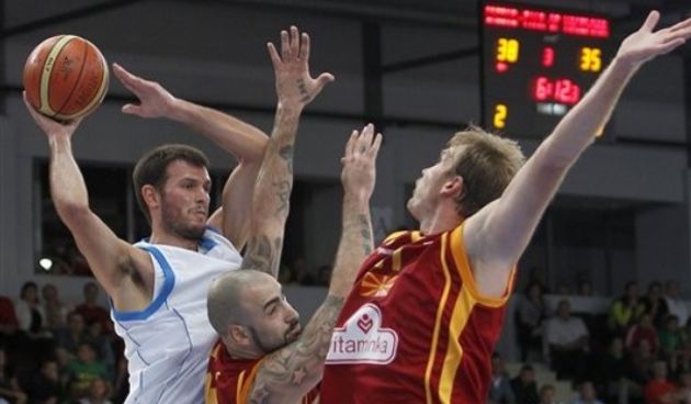 Antonios Fotsis is challenged by Pero Antic, center, and Todor Gecevski // AP Photo
