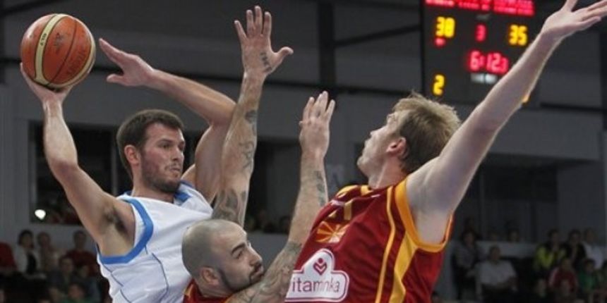 Antonios Fotsis is challenged by Pero Antic, center, and Todor Gecevski // AP Photo