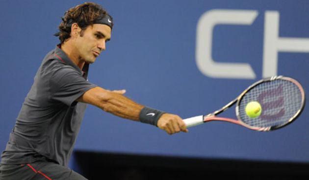 Roger Federer (SUI)[3] returns a shot to Jo-Wilfried Tsonga (FRA)[11] ] during a men’s singles quarterfinals match on Day 11 of the US Open.