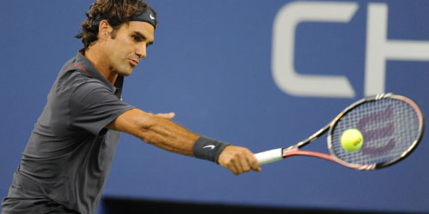 Roger Federer (SUI)[3] returns a shot to Jo-Wilfried Tsonga (FRA)[11] ] during a men’s singles quarterfinals match on Day 11 of the US Open.