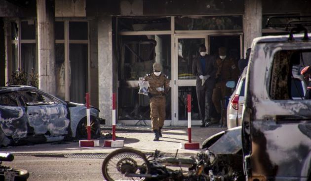 epa05105723 A military investigator from Burkina Faso carries evidence out of the Splendid Hotel in Ouagadougou, Burkina Faso 16 January 2016. According to media reports at least 23 people from 18 nationalities have been killed after Islamist militants at