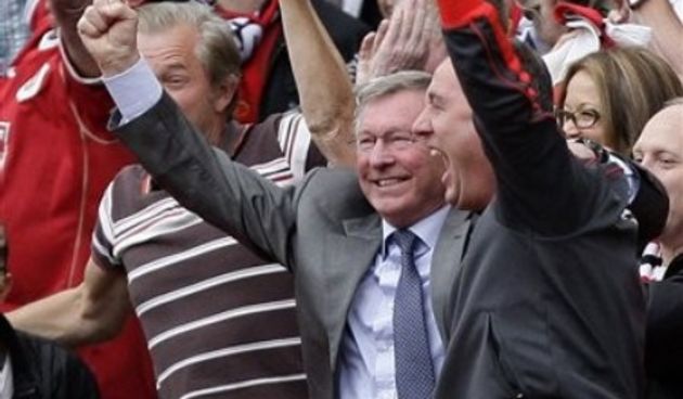 Manchester United manager Alex Ferguson, left, celebrates with first team coach Rene Meulensteen // AP Photo