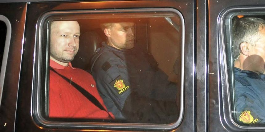 Bomb and terror suspect Anders Behring Breivik (red top) leaves the courthouse in a police car in Oslo on July 25, 2011, after the hearing to decide his further detention. Breivik will be held in solitary confinement for the first four weeks, with a ba Bomb and terror suspect Anders Behring Breivik (red top) leaves the courthouse in a police car in Oslo on July 25, 2011, after the hearing to decide his further detention. Breivik will be held in solitary confinement for the first four weeks, with a ba