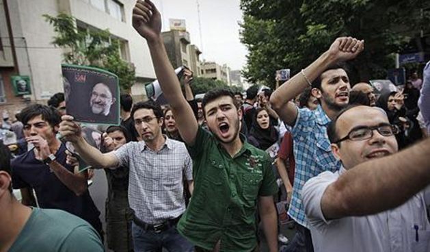 Supporters of reformist candidate Mir Hossein Mousavi, some wearing green, the color of the party, gather on the streets protesting the results of the Iranian presidential election in Tehran, Iran, Saturday, June 13, 2009. Iranian riot police have clashed