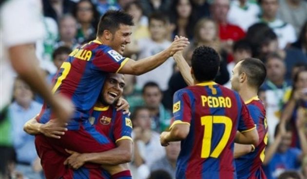 Barcelona’s David Villa, left top, celebrates with Daniel Alves of Brazil, bottom left, Pedro Rodriguez, center, and Andres Iniesta, right, after scoring against Racing de Santander during their La Liga soccer match at El Sardinero stadium in Santander, S