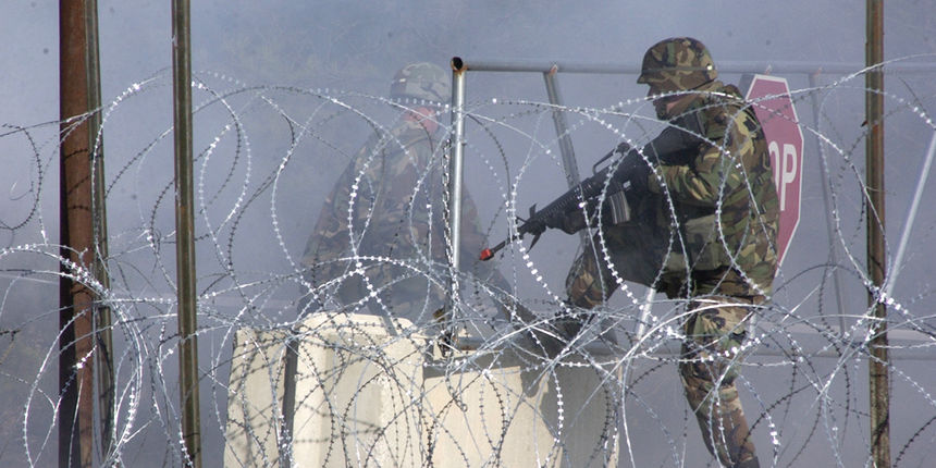 A security guard closed the gate after the locals attacked the base camp to gain access during the FOB exercise.

Photo by
SSG A. H. Scott