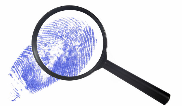 magnifying glass over a blue digital print