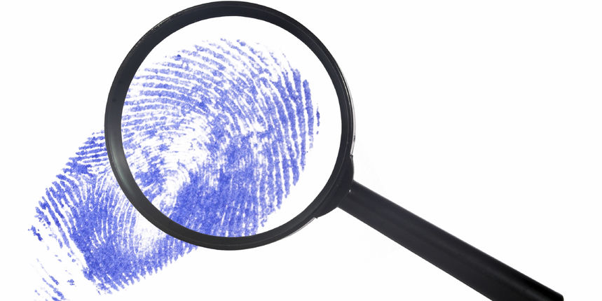 magnifying glass over a blue digital print magnifying glass over a blue digital print