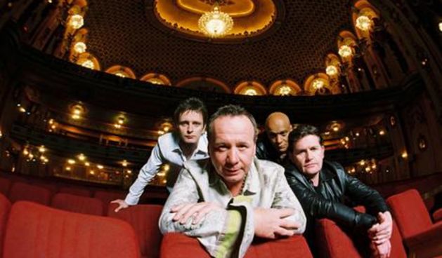 Simple Minds (from left to right) – Eddie Duffy (bass), Jim Kerr (vocals), Mel Gaynor (drums), Charlie Burchill (guitar) at the Sydney State Theatre in 2006.