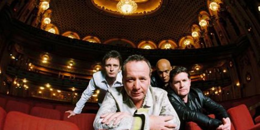 Simple Minds (from left to right) – Eddie Duffy (bass), Jim Kerr (vocals), Mel Gaynor (drums), Charlie Burchill (guitar) at the Sydney State Theatre in 2006. Simple Minds (from left to right) – Eddie Duffy (bass), Jim Kerr (vocals), Mel Gaynor (drums), Charlie Burchill (guitar) at the Sydney State Theatre in 2006.