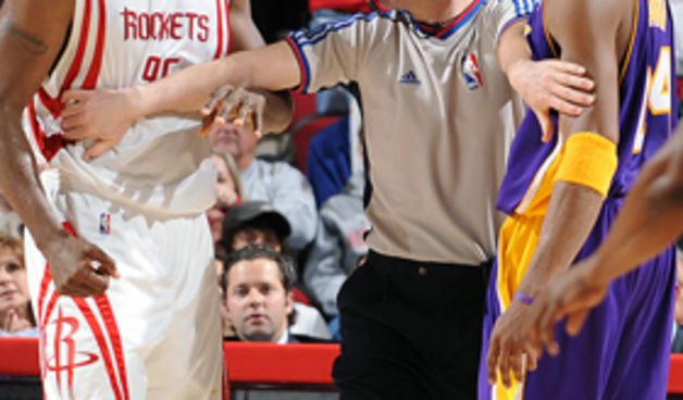 HOUSTON – MARCH 11: Ron Artest #96 of the Houston Rockets and Kobe Bryant #24 of the Los Angeles Lakers are separated by official Gary Zielinski #59 during the game at the Toyota Center March 11, 2009 in Houston, Texas. NOTE TO USER: User expressly acknow
