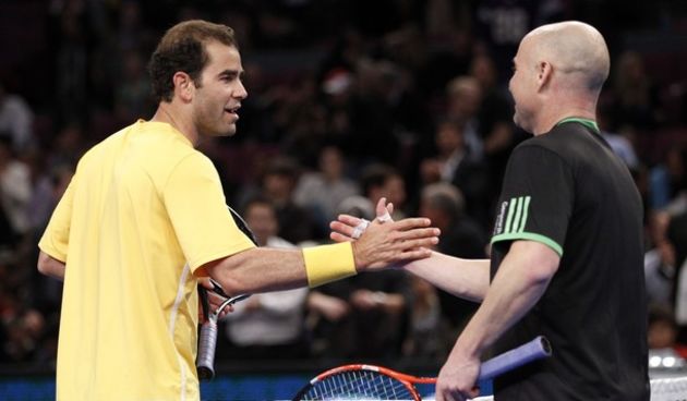 Tennis legend Pete Sampras (L) shakes hands with fellow legend Andre Agassi  // Reuters