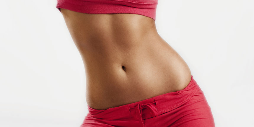 slim tanned tight womans body in sport wear, studio white