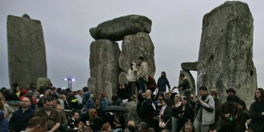People dance on Stonehenge monument in anticipation of the the summer solstice. People dance on Stonehenge monument in anticipation of the the summer solstice.