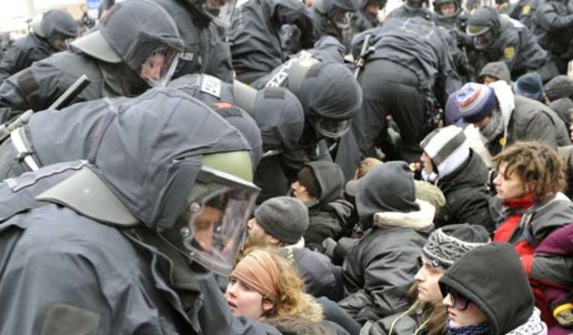 Police officers clear a blockade of demonstrators  during a rally to remember the victims of Dresden`s destruction at the end of WWII in Dresden, Germany, Saturday, Feb. 13, 2010.Thousands of neo-Nazis and their opponents protested Saturday in the eastern