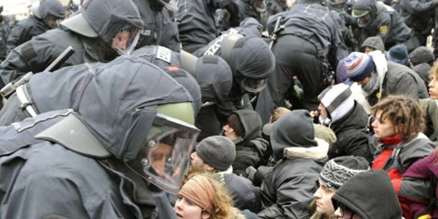Police officers clear a blockade of demonstrators  during a rally to remember the victims of Dresden`s destruction at the end of WWII in Dresden, Germany, Saturday, Feb. 13, 2010.Thousands of neo-Nazis and their opponents protested Saturday in the eastern