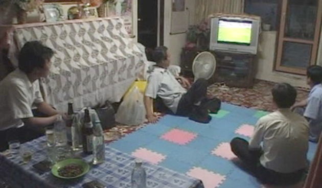 Relatives of the North Korean World Cup goalkeeper Ri Myong Guk watch the World cup soccer match against Portugal  live at home in Pyongyang Monday June 21, 2010.  North Korean state television aired full live coverage of the team’s 7-0 World Cup loss to