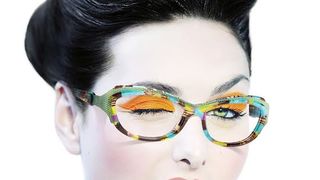 Model with fashionable hairstyle and orange eyeshadow winking. Model with fashionable hairstyle and orange eyeshadow winking.