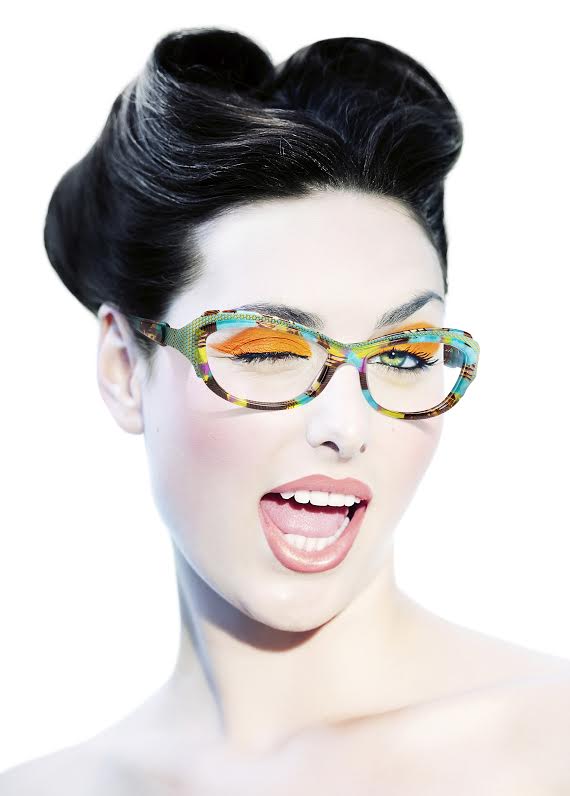 Model with fashionable hairstyle and orange eyeshadow winking. Model with fashionable hairstyle and orange eyeshadow winking.