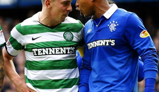 Celtic’s Scott Brown (L) talks with Rangers’ El Hadji Diouf  // Reuters