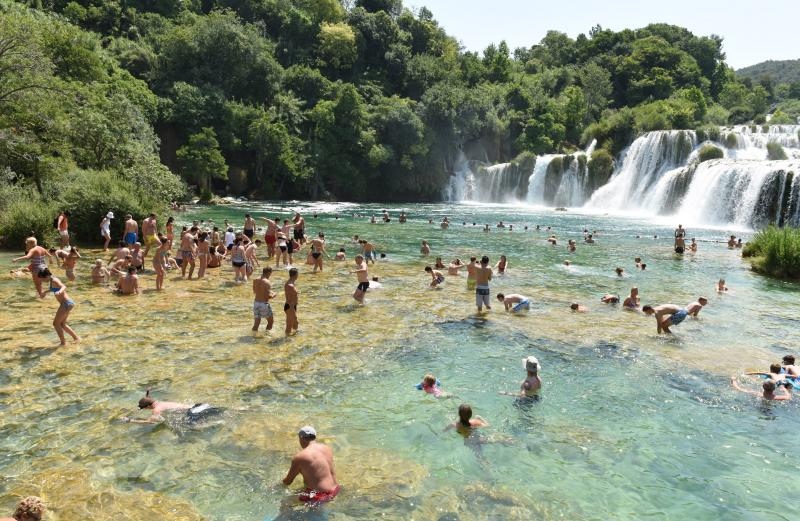 Paklene vrucine i visoke temperature natjerali su domace i strane goste da osvjzenje potraze u NP Krka. Photo: Hrvoje Jelavic/PIXSELL