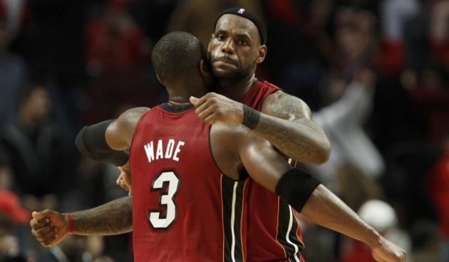LeBron James (R) is congratulated by teammate Dwyane Wade // Reuters