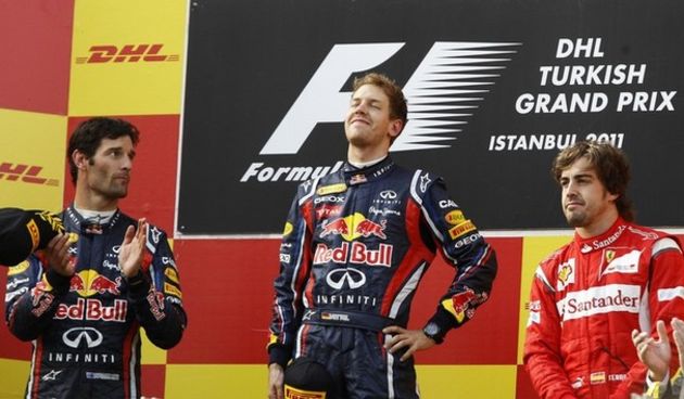 First placed Red Bull Formula One driver Sebastian Vettel of Germany (C), his team mate second placed Mark Webber of Australia (L) and third placed Ferrari Formula One driver Fernando Alonso of Spain  // Reuters