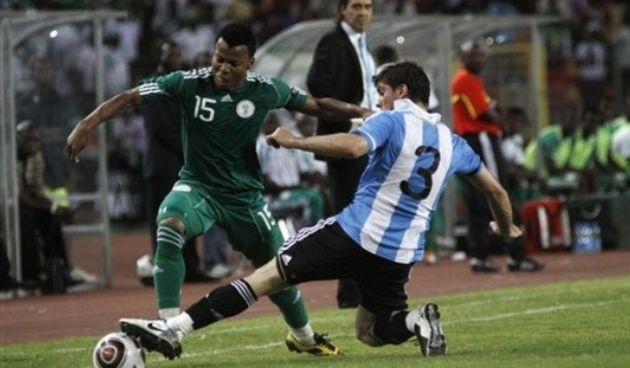 Nigerian Uche Ikechukwu, left is challenged by Argentina Insua Emiliano // AP Photo
