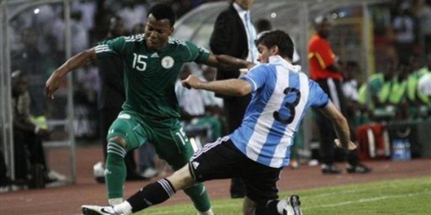 Nigerian Uche Ikechukwu, left is challenged by Argentina Insua Emiliano // AP Photo