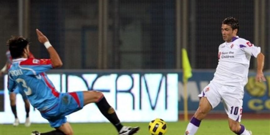 Catania Nicolas Spolli vies for the ball with Fiorentina Adrian Mutu // AP Photo